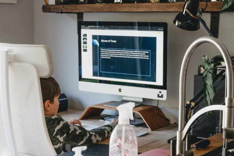 A child with an iep is sitting in front of a computer screen for homebound education.