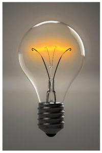 A lit incandescent light bulb with a glowing filament, reminiscent of ideas sparked by mom advocates, set against a neutral background.