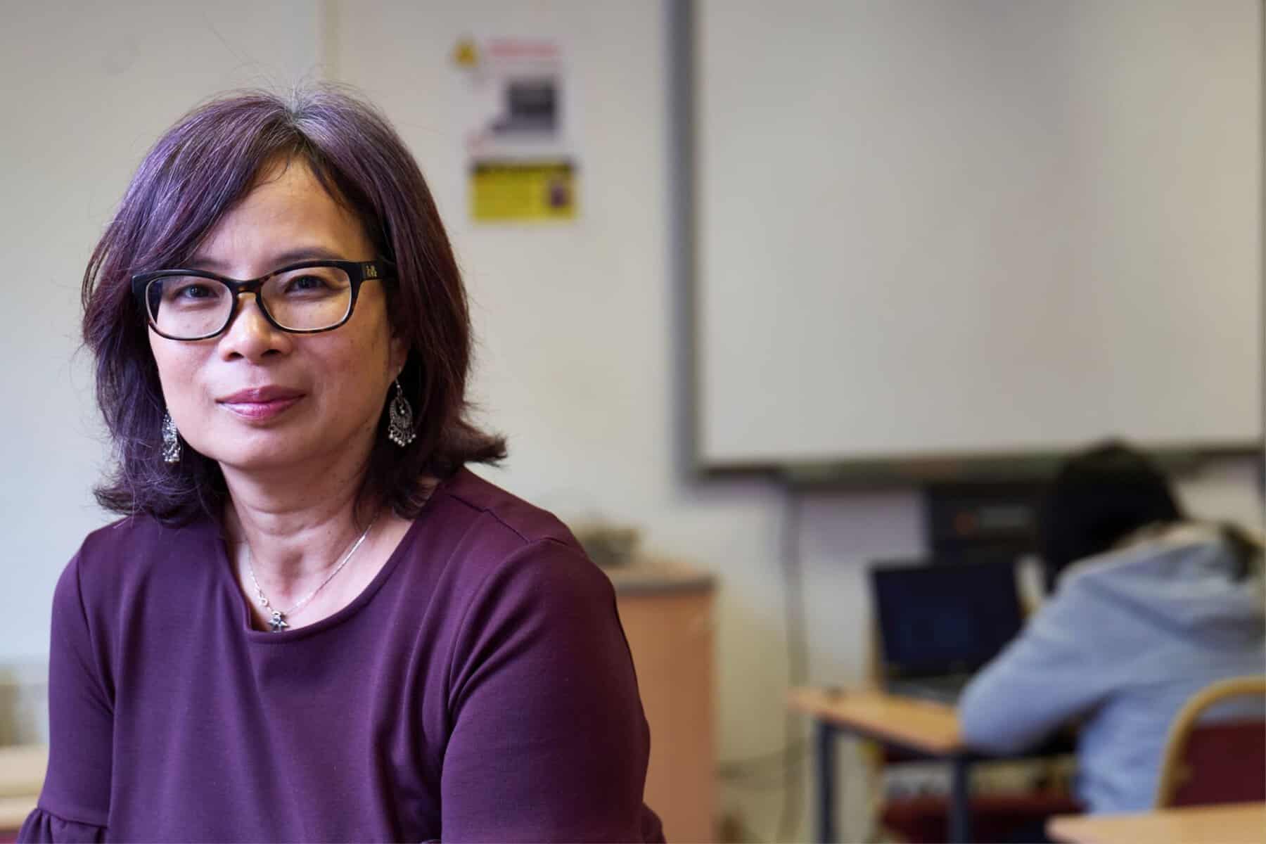A woman in glasses providing parent counseling and training in an iep classroom.