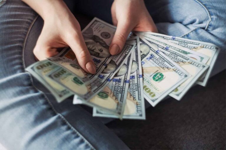 A woman is holding a bunch of money in her hands, wondering how much special education advocates cost.