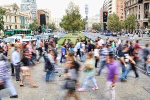 A blurry image of people crossing a street, highlighting transportation safety goals.