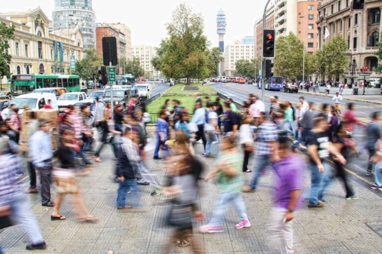 A blurry image of people crossing a street, highlighting transportation safety goals.