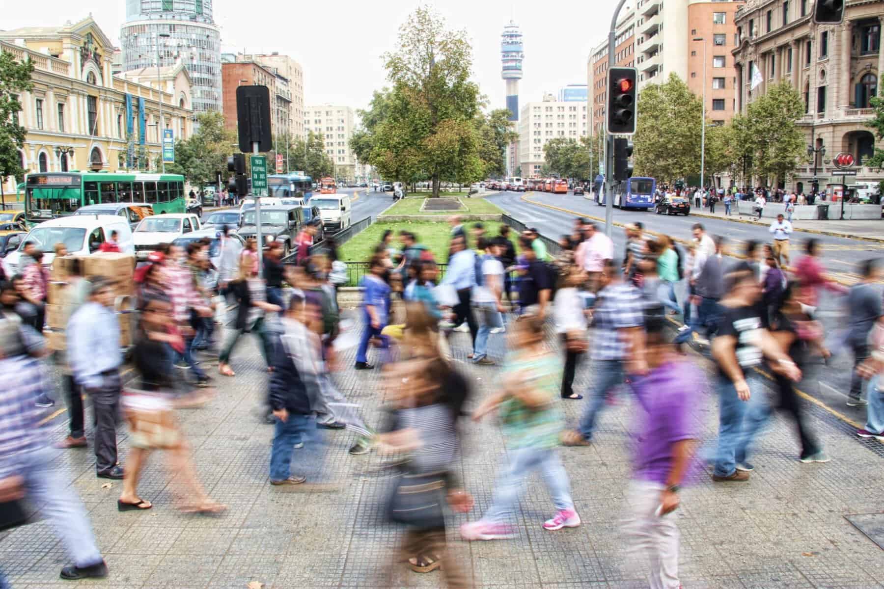 A blurry image of people crossing a street, highlighting transportation safety goals.