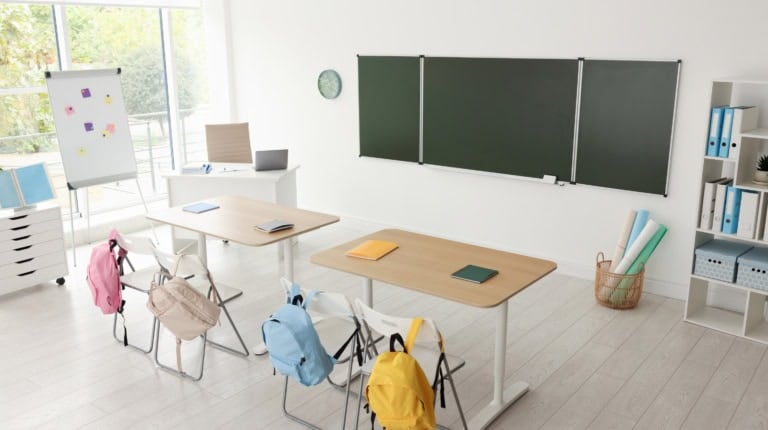 Elementary classroom with minimal visual clutter and neutral lighting to support visual access for students with cortical visual impairment.