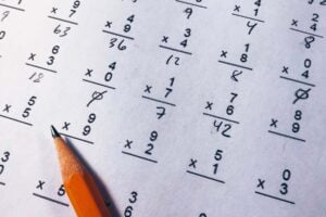 A pencil sits on top of a math multiplication sheet.