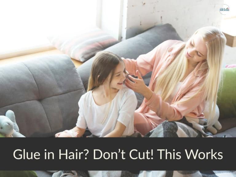 A mother gently combing her daughter’s hair to safely remove glue without cutting or damage.