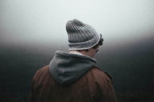 A man experiencing adhd rsd wearing a beanie on a foggy day.