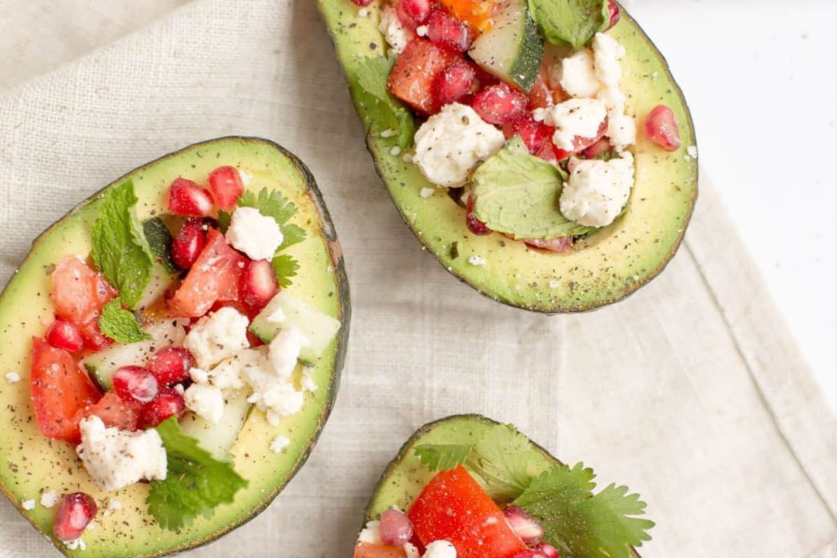 Nutritious avocado salad with the delightful addition of tangy pomegranate and creamy feta.