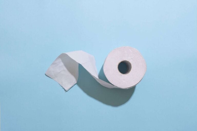 A roll of toilet paper on a blue background, perfect for potty training.