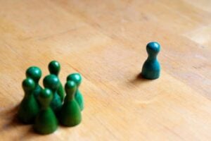 A set of green chess pieces on a wooden table.