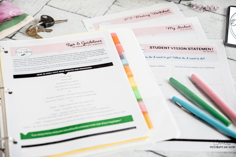 An open free iep binder with labeled dividers holds papers titled "tips & guidelines" and "student vision statement," alongside colorful pens on a white wood surface.