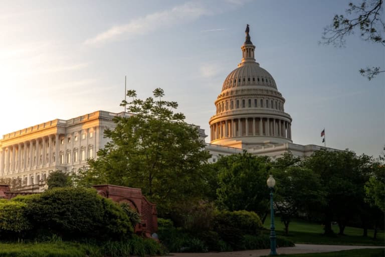 At sunset, the u. S. Capitol building stands majestically with its illuminated dome, symbolizing changing laws. The surrounding greenery and clear sky provide a serene backdrop to this beacon of legislative progress.