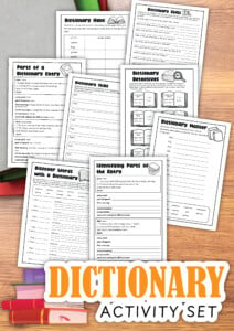 A set of printed worksheets titled "dictionary activity set," designed for teaching kids essential dictionary skills, is spread out on a wooden surface with some colored pencils.