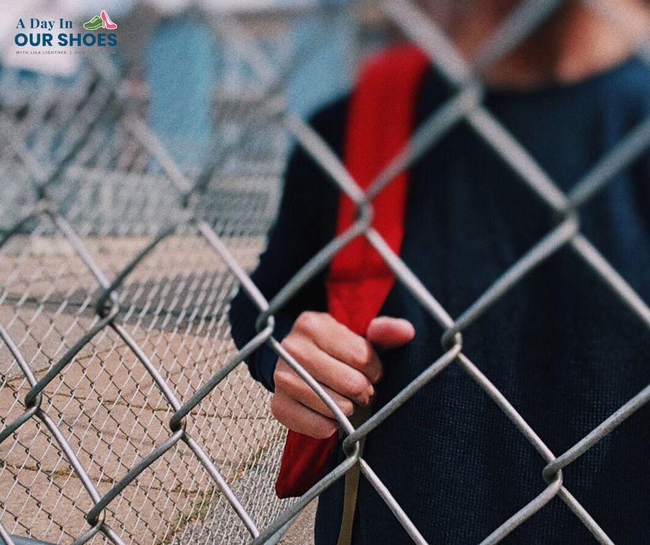 A person holding a red backpack stands behind a chain-link fence; their face is partially out of frame. The logo “a day in our shoes” appears in the top left corner, highlighting issues disabled students may face, such as counseling out from charter schools.
