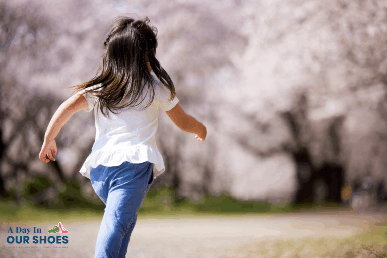 Young girl with long hair running outdoors on a path lined with blooming trees—capturing a joyful spring moment while highlighting autism safety. Logo “a day in our shoes” appears in the lower left corner.