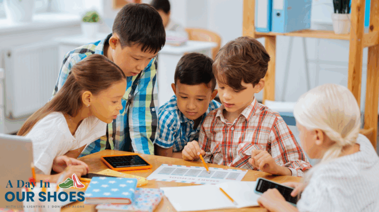 Five children sit around a table, examining a paper chart and using tablets and calculators in a classroom setting, exploring a sample GIEP. The "A Day in Our Shoes" logo appears in the bottom left corner.