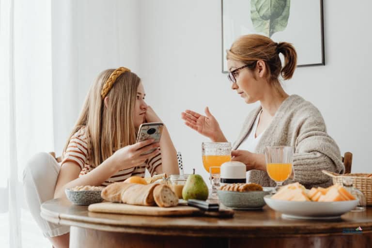Parent and teen daughter talking about future planning and her odd at the breakfast table
