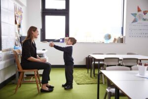 A boy giving his teacher a gift for teacher appreciation week