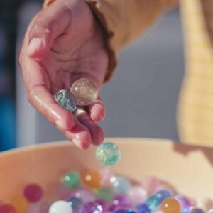 Child using marbles as a stim toy