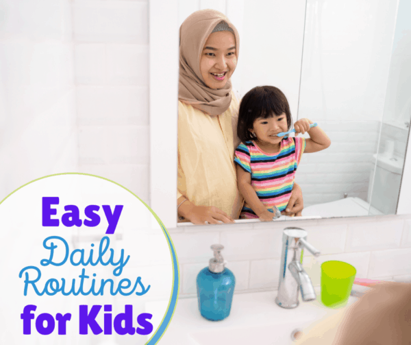 Mom helping her daughter with the daily routine of brushing her teeth