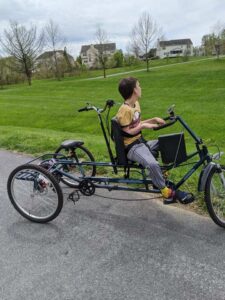 My autistic son riding our adaptive bike