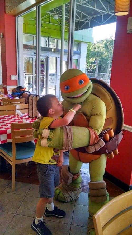 Young disabled boy greeting a ninja turtle in orlando