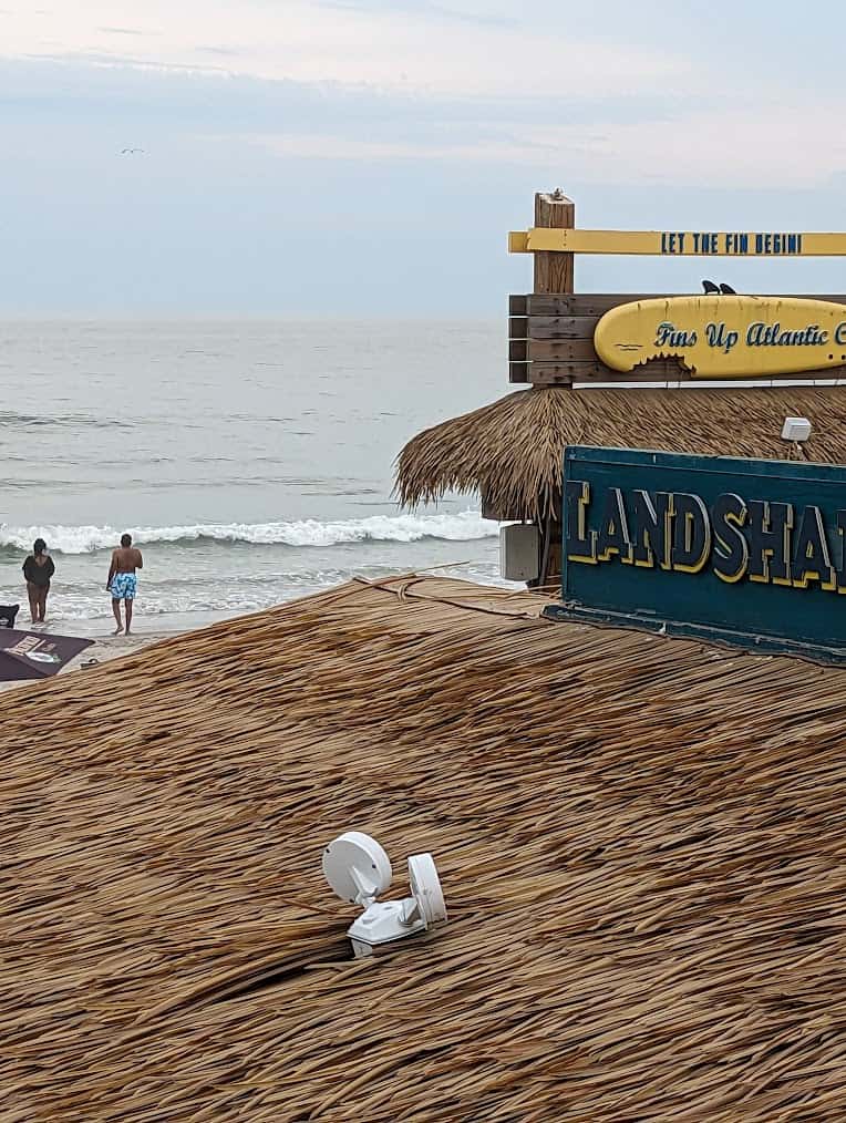 A beach hut with a playful sign that says landshark.