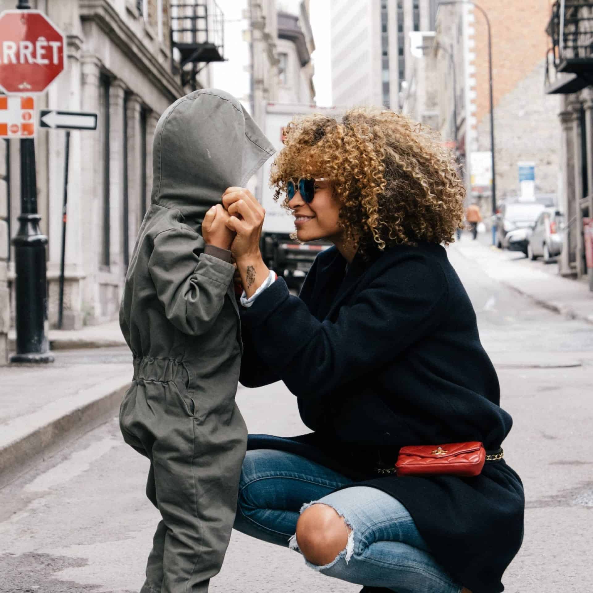 Mom tying a child's hood