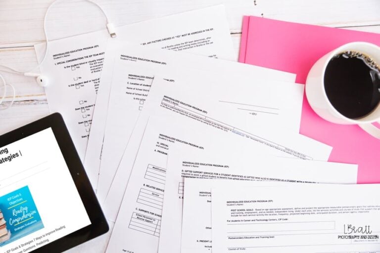 Printed iep paperwork spread across a desk with notes and documents related to special education eligibility and evaluations.