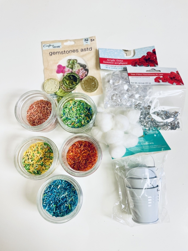 A st. Patrick's day sensory bin filled with a variety of items, including glitter and confetti.