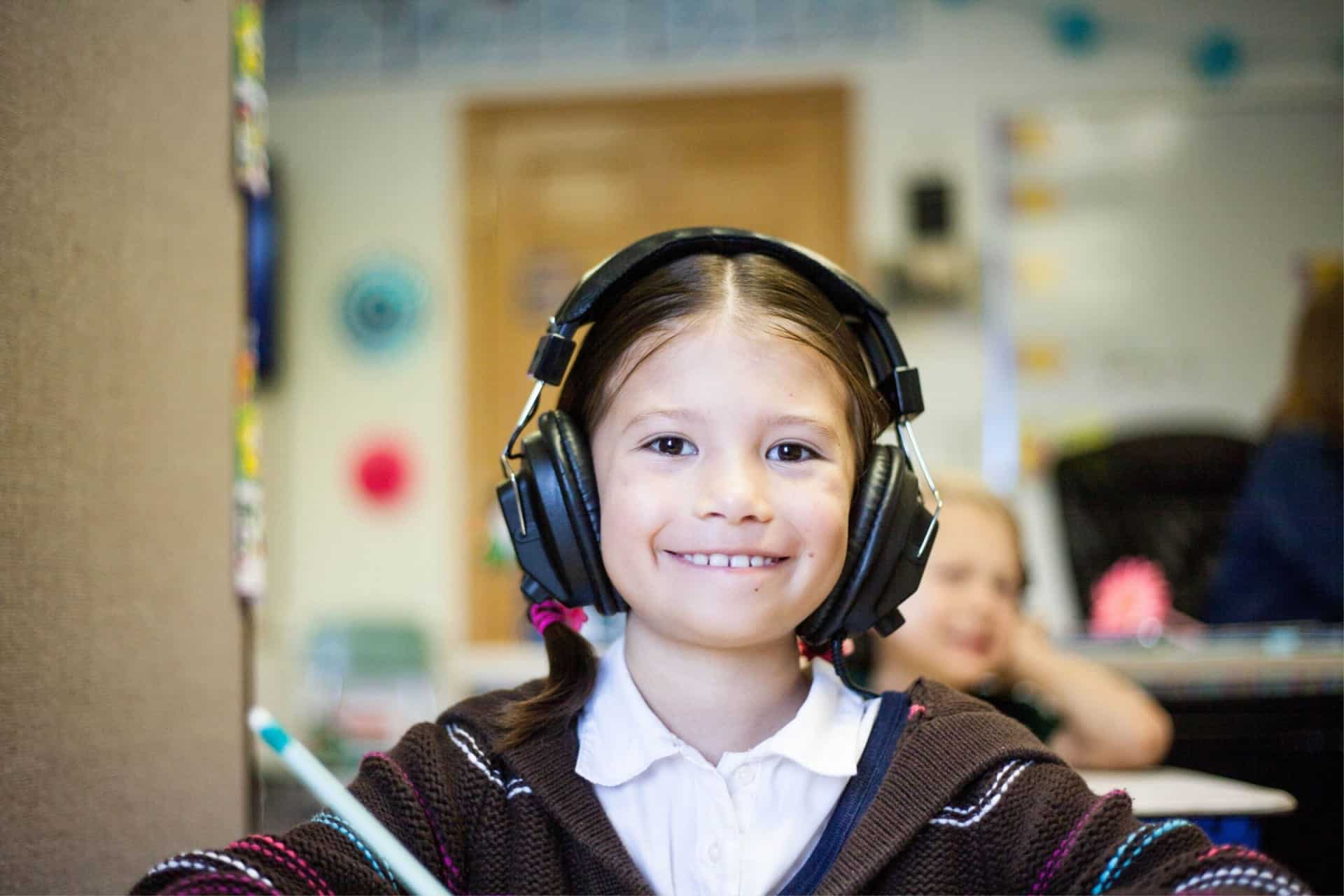 What is sdc in special education? A simple guide to special day class, for parents. 4 An sdc in special education: a simple guide for parents of a young girl wearing headphones in a classroom.