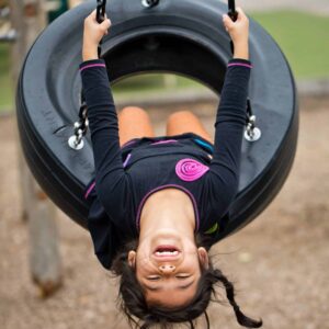 Young girl on tire swing