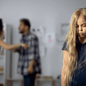 A young girl is standing in front of a group of people, receiving 504 accommodations for trauma or ptsd.