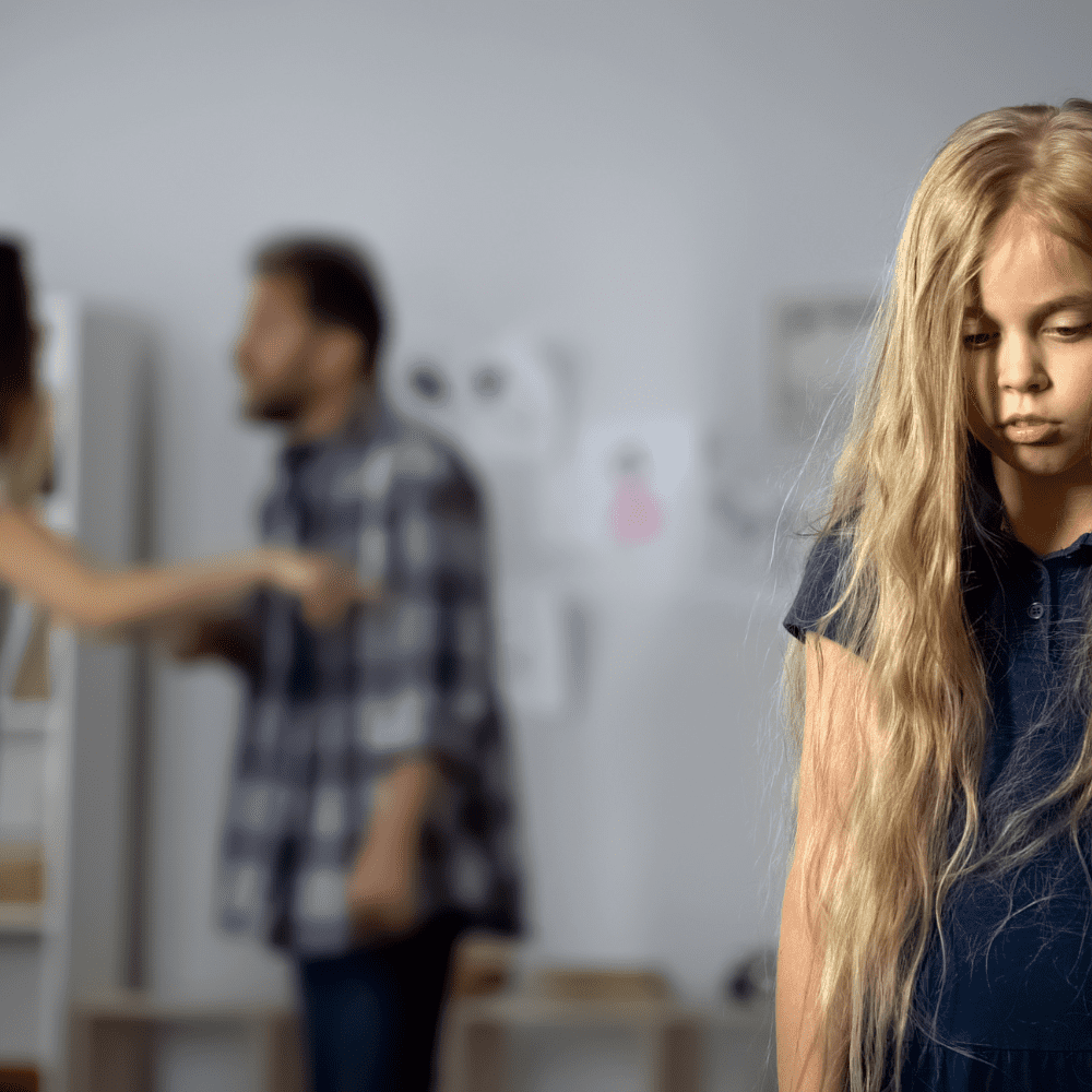A young girl is standing in front of a group of people, receiving 504 accommodations for trauma or ptsd.